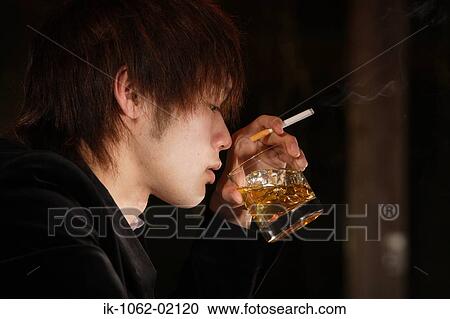 Japanese man holding a cigarette and drinking scotch-whiskey View Large Photo Image Stock Image - Japanese man holding a cigarette and drinking scotch-whiskey. Fotosearch