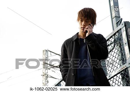 Stock Photography - Japanese man on break talking on the phone. Fotosearch