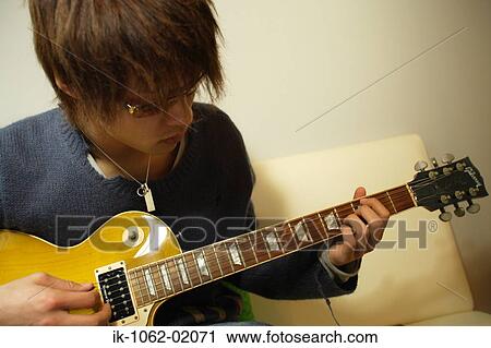 Japanese man strumming the guitar View Large Photo Image Stock Image - Japanese man strumming the guitar. Fotosearch