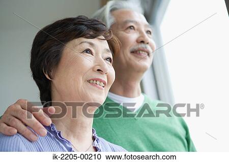 Stock Image - Japanese senior couple smiling together. Fotosearch