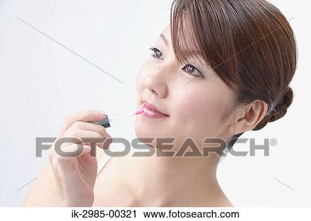 Japanese Woman Applying Lip Gloss View Large Photo Image Stock Image - Japanese Woman Applying Lip Gloss. Fotosearch