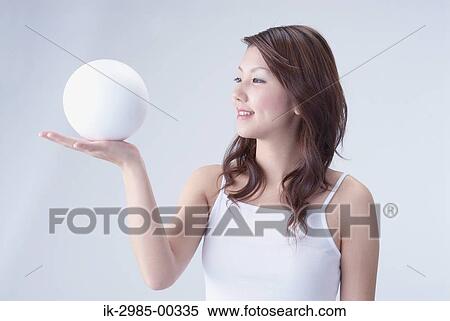 Stock Photography - Japanese Woman Holding Ball. Fotosearch