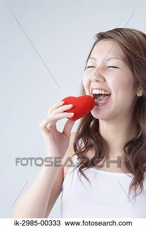 Japanese Woman Laughing While Holding Heart View Large Photo Image Stock Image - Japanese Woman Laughing While Holding Heart. Fotosearch