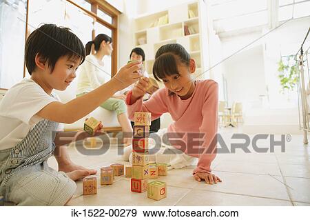 Stock Photo - Kids Playing with Alphabet Blocks. Fotosearch