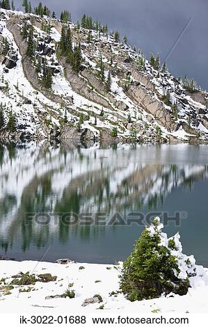 Lake with Snow-Capped Mountains in Banff, Canada View Large Photo Image Stock Photo - Lake with Snow-Capped Mountains in Banff, Canada. Fotosearch