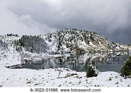 Lake with Snow-Capped Mountains in Banff, Canada View Large Photo Image Stock Photograph - Lake with Snow-Capped Mountains in Banff, Canada. Fotosearch
