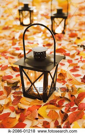 Stock Photo - Lantern with Fallen Leaves on Floor. Fotosearch