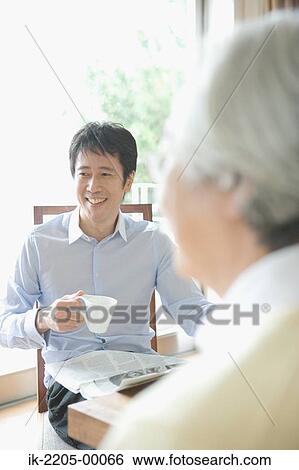 Mature man holding a newspaper and smiling View Large Photo Image Stock Photograph - Mature man holding a newspaper and smiling. Fotosearch