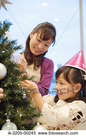 Mother and daughter decorating xmas tree View Large Photo Image Stock Image - Mother and daughter decorating xmas tree. Fotosearch