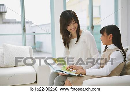 Stock Photo - Mother and Daughter Reading a Book. Fotosearch