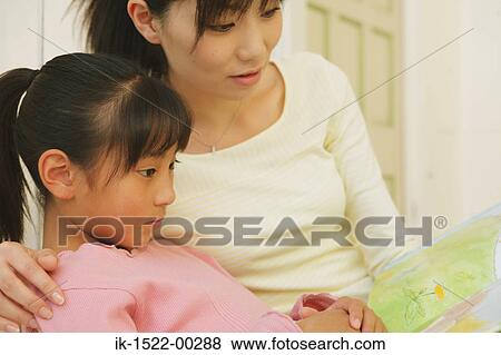 MOther and Daughter Reading Book View Large Photo Image Stock Photo - MOther and Daughter Reading Book. Fotosearch