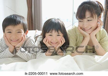 Mother and her children on bed View Large Photo Image Stock Image - Mother and her children on bed. Fotosearch