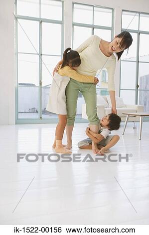 Stock Photograph - Mother Handing her Children. Fotosearch