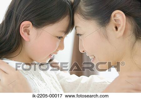 Mother leaning her head against daughter View Large Photo Image Stock Photo - Mother leaning her head against daughter. Fotosearch