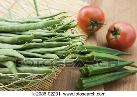 Okra, tomatoes and french beans lying on mat View Large Photo Image Stock Image - Okra, tomatoes and french beans lying on mat. Fotosearch