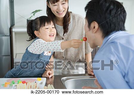 Parents with their daughter having breakfast View Large Photo Image Stock Image - Parents with their daughter having breakfast. Fotosearch