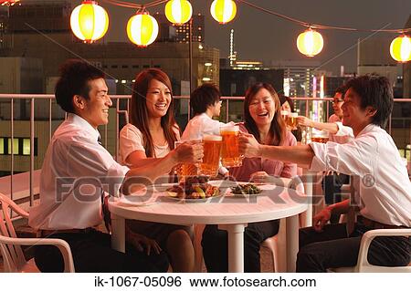 Stock Photograph - People Enjoying Beer and Snacks. Fotosearch