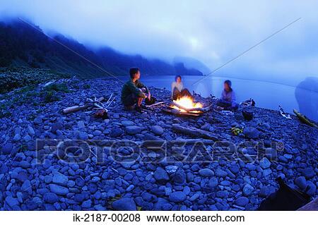 People Sitting Around Bonfire on Beach View Large Photo Image Stock Photo - People Sitting Around Bonfire on Beach. Fotosearch
