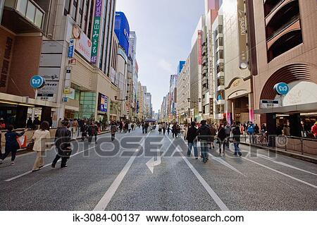 Stock Photo - People walking on road in marketplace. Fotosearch
