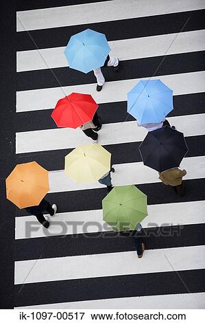 People Walking with Umbrellas View Large Photo Image Stock Photo - People Walking with Umbrellas. Fotosearch