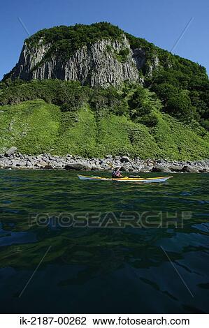 Stock Image - Person Boating at the Edge of River, Japan. Fotosearch