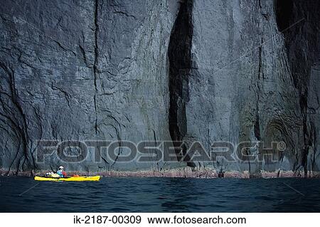 Stock Photo - Person Boating on Kayak Near Cliff, Hokkaido, Japan . Fotosearch
