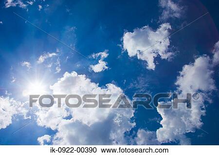 Stock Image - Rays of Sunlight Beam Passing Through Cloudy Sky. Fotosearch