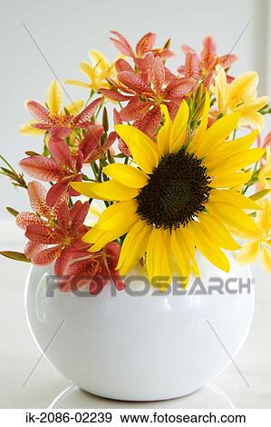 Stock Photo - Red and yellow lilies in a vase. Fotosearch