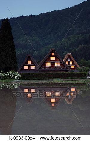 Stock Image - Reflection of Japanese House in Water, Japan, Gifu Prefecture. Fotosearch