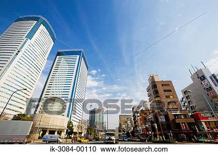 Stock Image - Road with buildings in downtown. Fotosearch