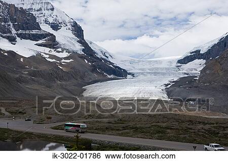 Road with Snowcapped Mountains against Cloudy Sky View Large Photo Image Stock Photograph - Road with Snowcapped Mountains against Cloudy Sky . Fotosearch
