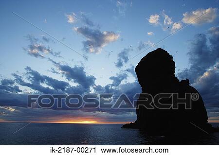 Stock Image - Scenic View of Sunset Over River. Fotosearch