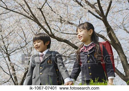 Schoolmate holding hands and going to school View Large Photo Image Stock Image - Schoolmate holding hands and going to school. Fotosearch