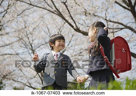 Schoolmate holding hands and going to school View Large Photo Image Stock Image - Schoolmate holding hands and going to school. Fotosearch
