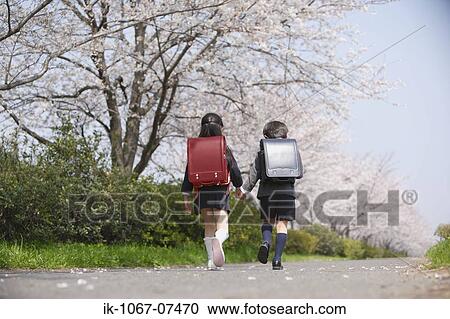 Schoolmate holding hands and going to school View Large Photo Image Stock Image - Schoolmate holding hands and going to school. Fotosearch