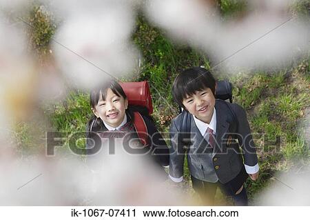 Stock Image - Schoolmate holding hands and looking up. Fotosearch