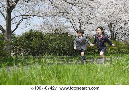 Schoolmate running by holding hands View Large Photo Image Stock Photo - Schoolmate running by holding hands. Fotosearch