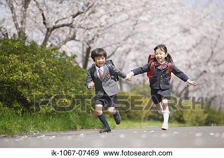 Stock Photo - Schoolmate running on road . Fotosearch