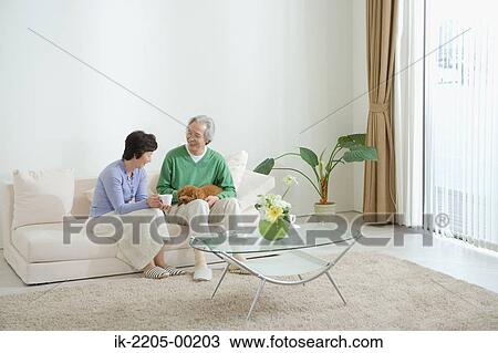 Senior couple on couch with their dog View Large Photo Image Stock Image - Senior couple on couch with their dog. Fotosearch