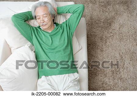 Senior man relaxing on couch View Large Photo Image Stock Image - Senior man relaxing on couch. Fotosearch