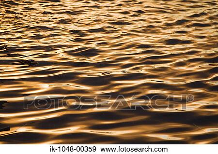 Shimmering water rippples of sea at dusk View Large Photo Image Stock Photo - Shimmering water rippples of sea at dusk. Fotosearch