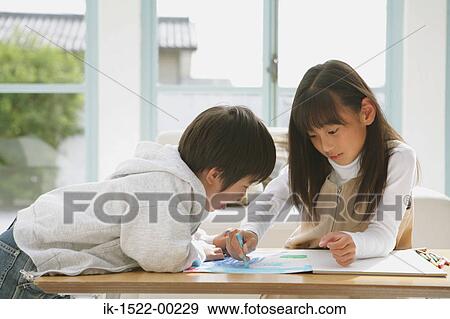 Stock Photo - Siblings Drawing and Having Fun. Fotosearch