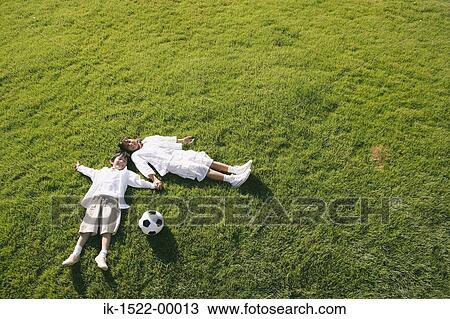 Siblings Laying Down on Grass View Large Photo Image Stock Image - Siblings Laying Down on Grass. Fotosearch