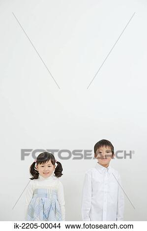 Picture - Siblings standing and looking at camera. Fotosearch