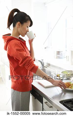 Side view of a woman having beverage with snack View Large Photo Image Stock Photography - Side view of a woman having beverage with snack. Fotosearch