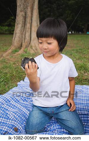 Smiling boy enjoying chocolate cake View Large Photo Image Stock Photo - Smiling boy enjoying chocolate cake. Fotosearch