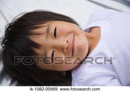 Stock Photo - Smiling boy looking at camera. Fotosearch