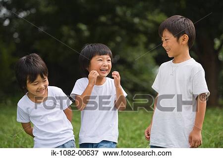 Smiling children standing in park View Large Photo Image Stock Photo - Smiling children standing in park. Fotosearch