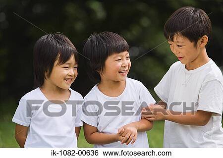 Smiling children talking in park View Large Photo Image Stock Photograph - Smiling children talking in park. Fotosearch
