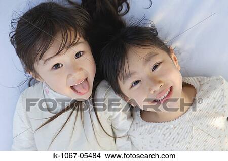 Smiling girls looking at camera View Large Photo Image Picture - Smiling girls looking at camera. Fotosearch